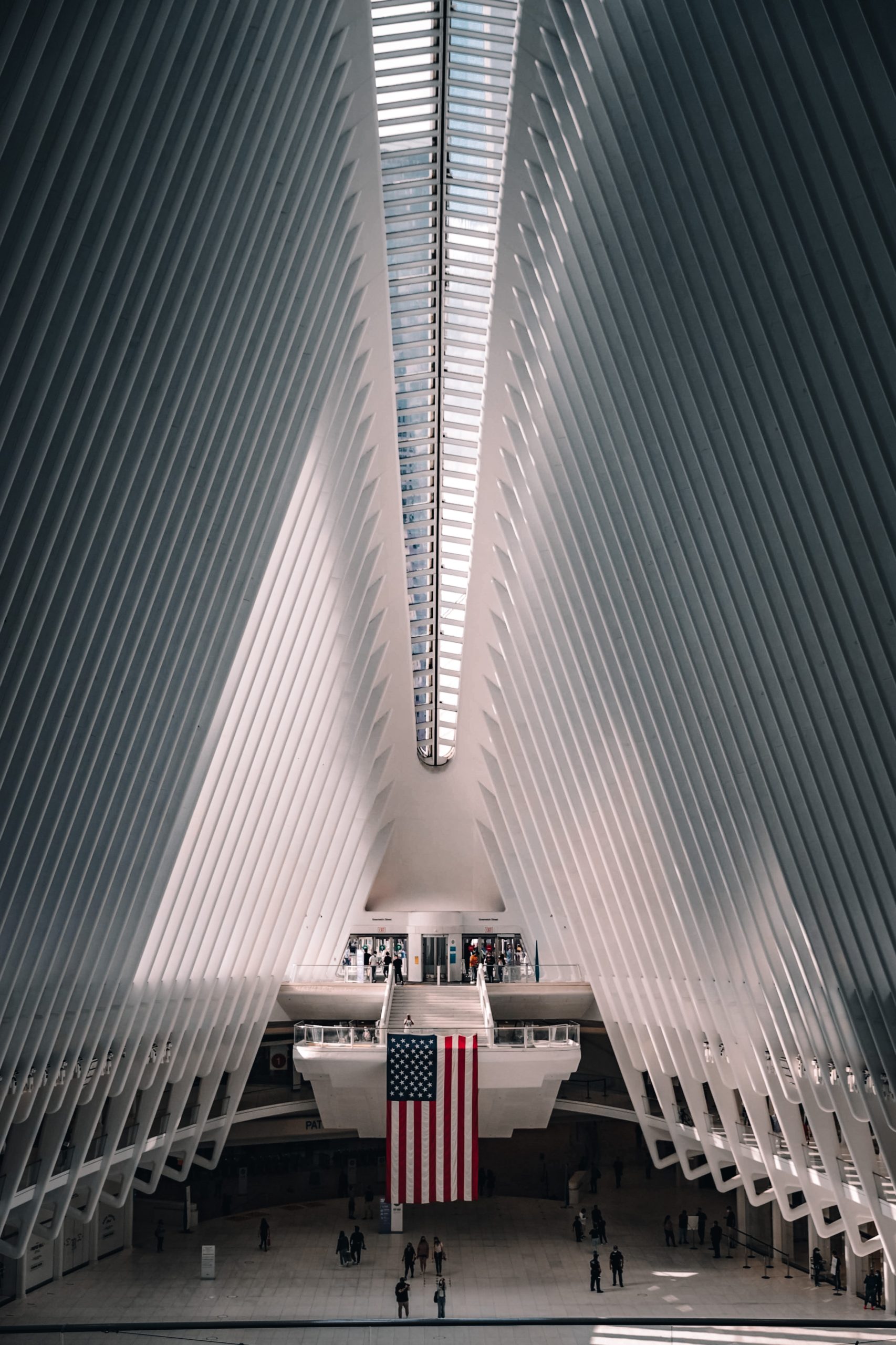 Spacious modern monochromatic building in white featuring a United States flag.